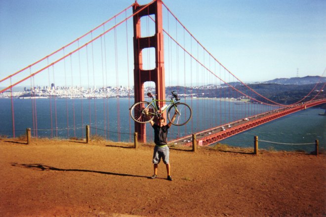 PH holding up his bicycle near the Golden Gate bridge